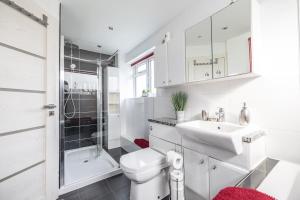 a white bathroom with a toilet and a sink at Hot Tub and Garden Spacious Unique 3 Bed House in Allesley +28 photos