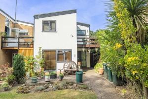a house with a wheel in a garden at Hot Tub and Garden Spacious Unique 3 Bed House in Allesley