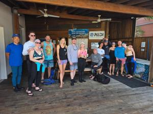 a group of people posing for a picture at Naboo Resort & Dive Center - Adults Only in West Bay