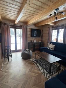 a living room with a blue couch and a table at Zrub pod vŕškom in Osturňa