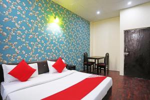 a bedroom with a bed and a blue wall at Hotel O Platinum Inn in Faridabad
