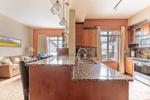 a kitchen with a sink and a counter top at Sun Drenched Escape in Canmore