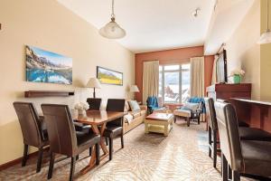 a living room with a table and a couch at Sun Drenched Escape in Canmore