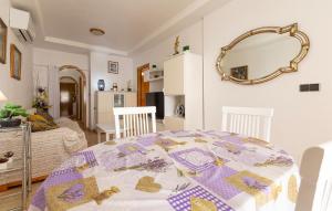 a dining room with a table and a mirror at 2 Bedroom Amazing Apartment In Torrevieja in Torrevieja