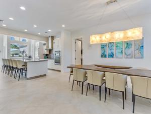 a kitchen and dining room with a table and chairs at Casa Captiva - Deluxe 5 Bedroom Villa Steps to Beach in Captiva