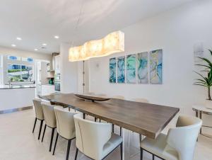 a dining room with a wooden table and chairs at Casa Captiva - Deluxe 5 Bedroom Villa Steps to Beach in Captiva