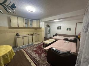 a room with two beds and a kitchen with a table at Apartment Little Village in Plav