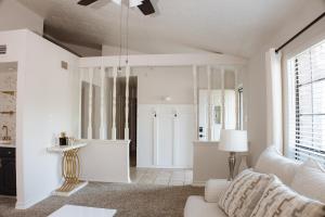 a living room with a couch and a table at The Cooper Nest in Garland +26 photos