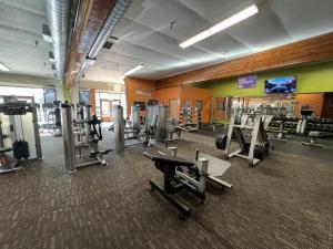 a gym with treadmills and machines in a room at The Queen On Main in Winters