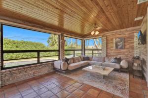 a living room with a couch and a table at Alfresco Beach Getaway in Pompano Beach