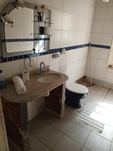 a bathroom with a sink and a toilet at Chácara maria bonita in Rio Branco