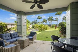a patio with chairs and tables and a ceiling fan at Pili Mai 5D condo in Koloa