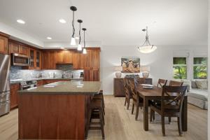 a kitchen and living room with a table and chairs at Pili Mai 5D condo in Koloa +40 photos