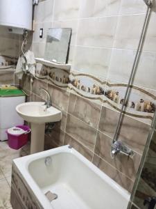a bathroom with a bath tub and a sink at Enjoy 2025 in Alexandria