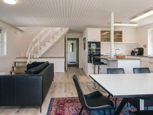a living room with a couch and a table at 4 star holiday home in Nørre Nebel in Nørre Nebel