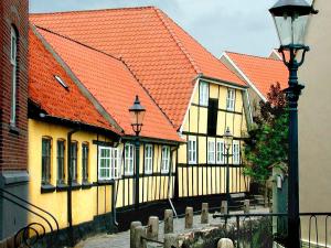 a row of buildings with orange roofs and a street light at 5 person holiday park in Bogense in Bogense