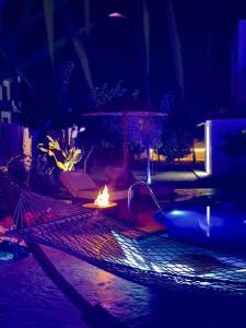 a fire pit in a backyard at night at La casa di pantelis with Luxury Pool in Archangelos