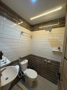 a bathroom with a toilet and a sink at The View Pyramids Gold one in Cairo