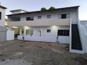a white house with a staircase in front of it at Casa Praia do Centro Rio das Ostras 1 in Rio das Ostras +26 photos