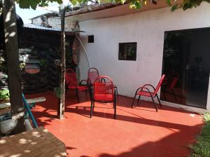 a patio with red chairs sitting on a patio at Miraflores 2- Calor de Hogar in Asuncion