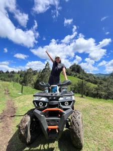 a woman standing on a four wheeler in a field at Glamping Milagros in San Pedro +15 photos
