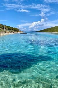 una gran masa de agua con una playa en el fondo en Seaside holiday house Ist - 14366, en Ist
