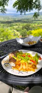 a plate of food with french fries on a table at Mirador Escondido del Chicamocha a 22km de Barichara in Villanueva