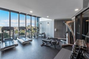 a gym with a bunch of treadmills and machines at Top Floor Stylish 1BR Apt in Southbank View Pool Gym in Melbourne