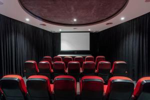 a conference room with red chairs and a screen at Top Floor Stylish 1BR Apt in Southbank View Pool Gym in Melbourne +26 photos