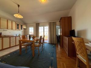 a kitchen and dining room with a table and chairs at Apartments by the sea Kukljica, Ugljan - 24795 in Kukljica +17 photos