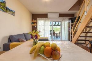 a bowl of fruit on a table in a living room at Holiday house with a parking space Srb, Zagora - 24378 in Srb