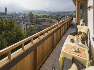a balcony with a table and a view of a city at - Chalet Panorama View in Kössen +11 photos