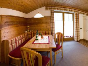 a dining room with a wooden table and chairs at Holiday apartment with 2 bedrooms in Dorfgastein