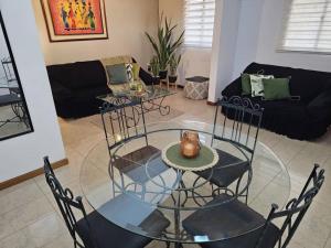 a glass table and chairs in a living room at Lecheria exclusivo con muelle in El Morto de Barcelona