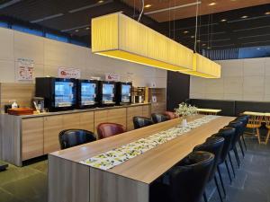 a dining room with a long table and chairs at Tokyu Stay Kamata - Tokyo Haneda in Tokyo