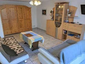a living room with a couch and a table at Holiday Home in Pfaffenweiler in Pfaffenweiler