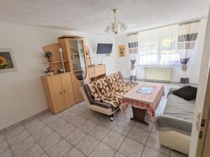 a living room with a couch and a table at Holiday Home in Pfaffenweiler in Pfaffenweiler