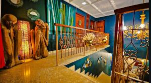 a room with a staircase with paintings on the wall at ORHO Hotel Boutique Marbella Panama City in Panama City