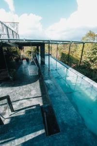 a swimming pool with a swing in a house at Ekumal Retreat Eco Sanctuary in Akumal
