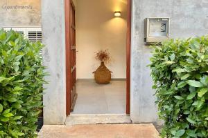 a hallway with a vase next to a building at Apartments by the sea Ist - 22436 in Ist
