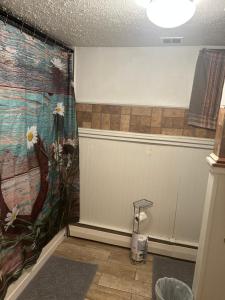 a bathroom with a mural of flowers on the wall at Slightwork in Gillette