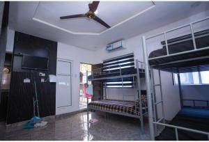a room with two bunk beds and a ceiling fan at tephraLINK in Lagos