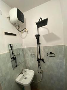 a bathroom with a shower and a toilet and a sink at tephraLINK in Lagos