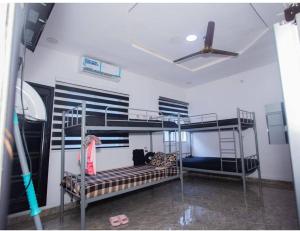 two bunk beds in a room with a ceiling fan at tephraLINK in Lagos