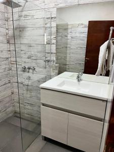 a bathroom with a sink and a glass shower at Patta Tickan in El Peñón