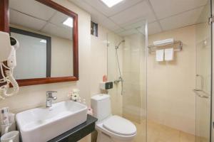 a bathroom with a toilet and a sink and a shower at Glow Sapa Hotel in Sapa +46 photos