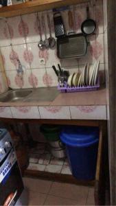 a kitchen counter with a sink and utensils at Sacha studio chic etoug ebe in Yaoundé