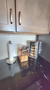 a kitchen counter with a bunch of breads and a paper towel at Modern 3-Story Townhome in Omaha +23 photos