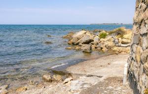 a rocky beach with the ocean in the background at Cozy Home In Tarquinia Vt With Wifi in Tarquinia