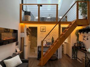 a living room with a staircase in a house at Cozy tiny house 10 minutes from UGA in Athens